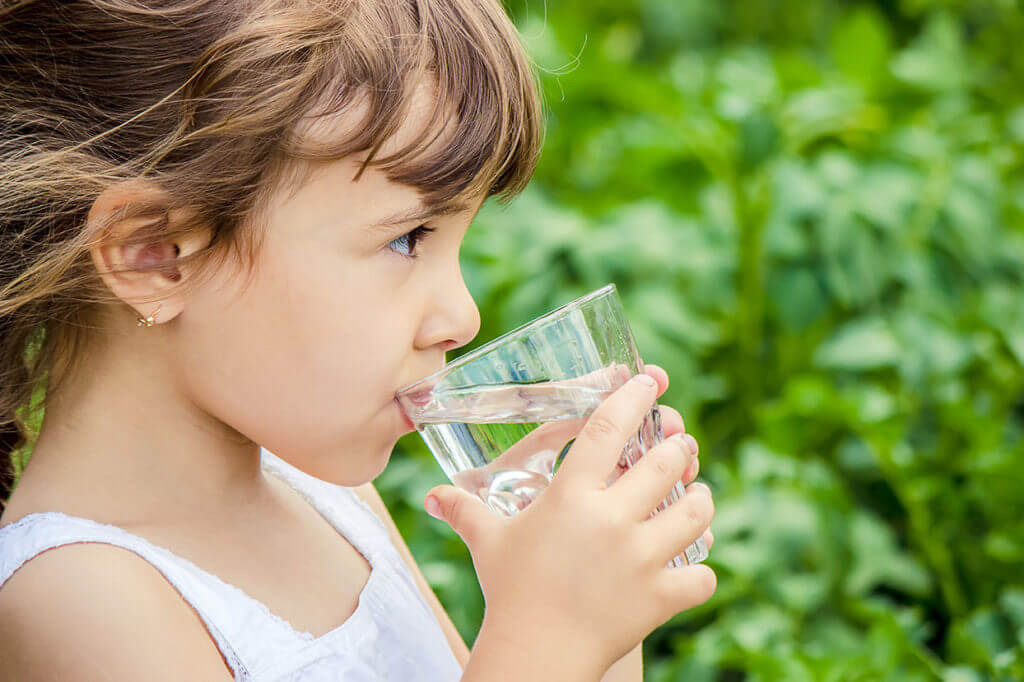 Kid drinking glass of water