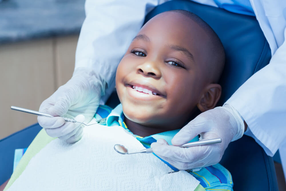 Close up of a boy having his teeth examined by dentist