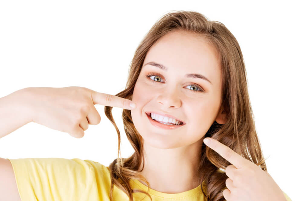 Teenager who has had teeth whitening procedure