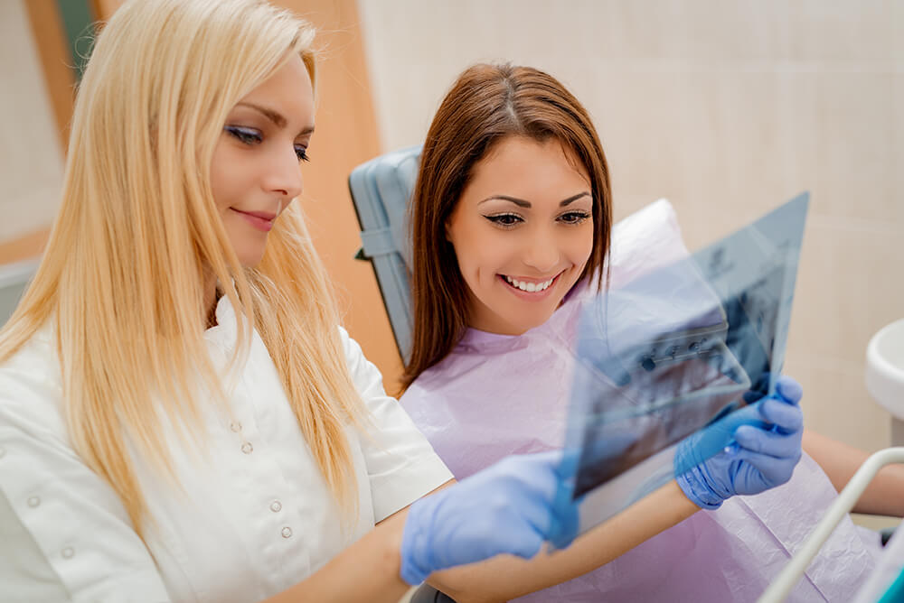 Dentist showing X-Ray to a patient