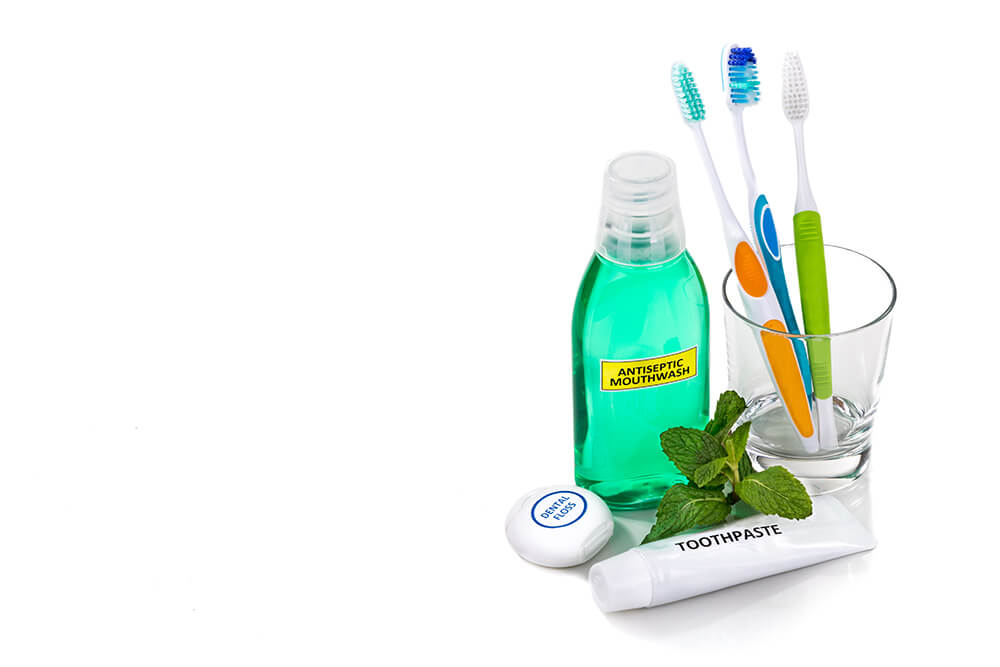 A pile of dental hygiene products sitting on a white table