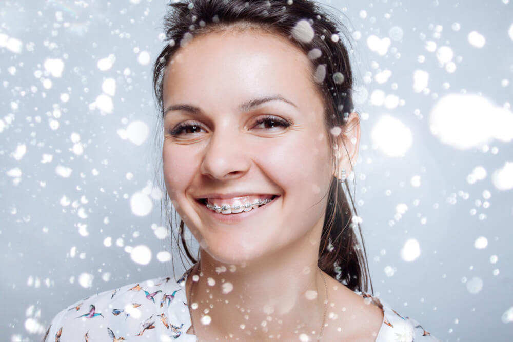 Young woman with braces in the snow.
