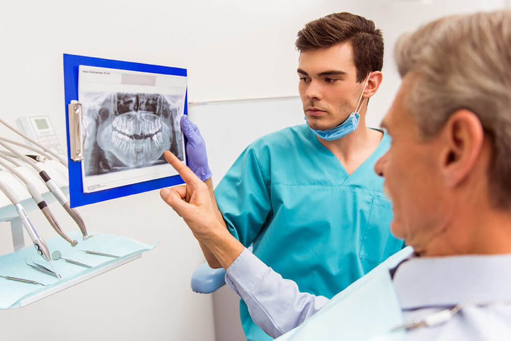 Man deciding whether or not to get dental implants