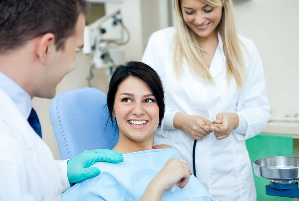 Woman receiving professional teeth whitening procedure