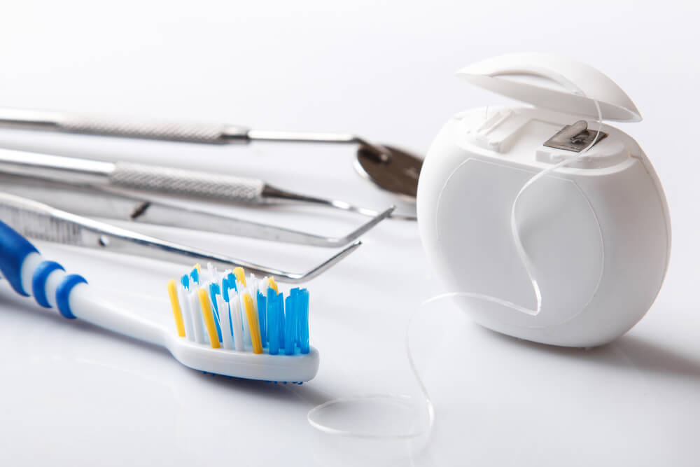 General dentistry - toothbrush, floss and dentist tools.
