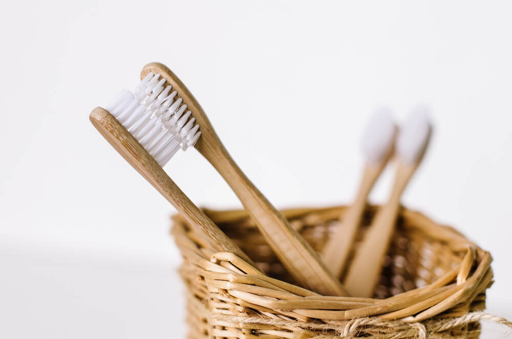 Bamboo toothbrushes sitting in a basket