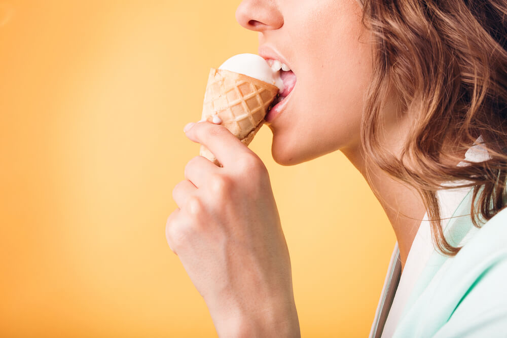 ○ Woman eating ice cream with her teeth