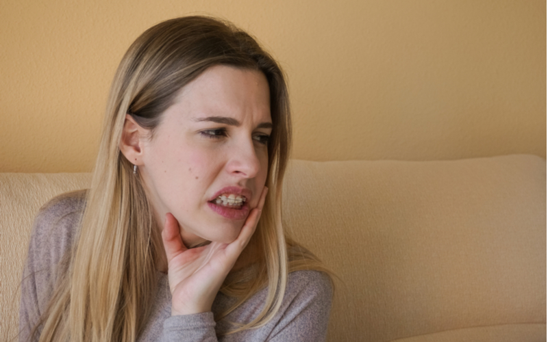 Woman suffering from mouth sores from braces