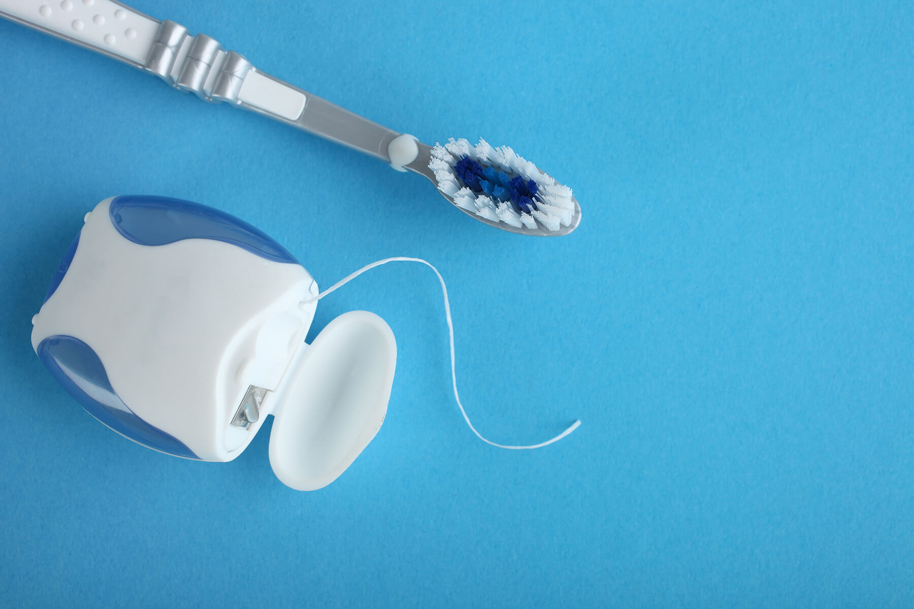 Toothbrush and floss laying on a table