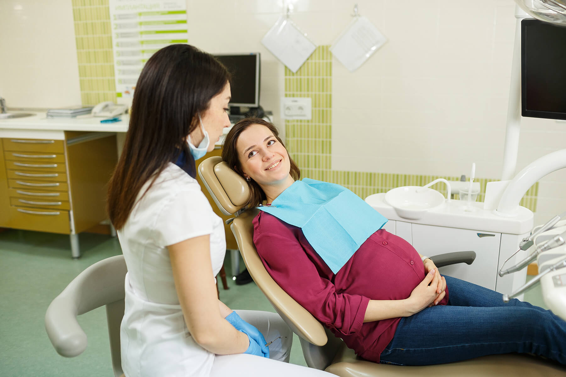 Pregnant woman sitting in dentist chair