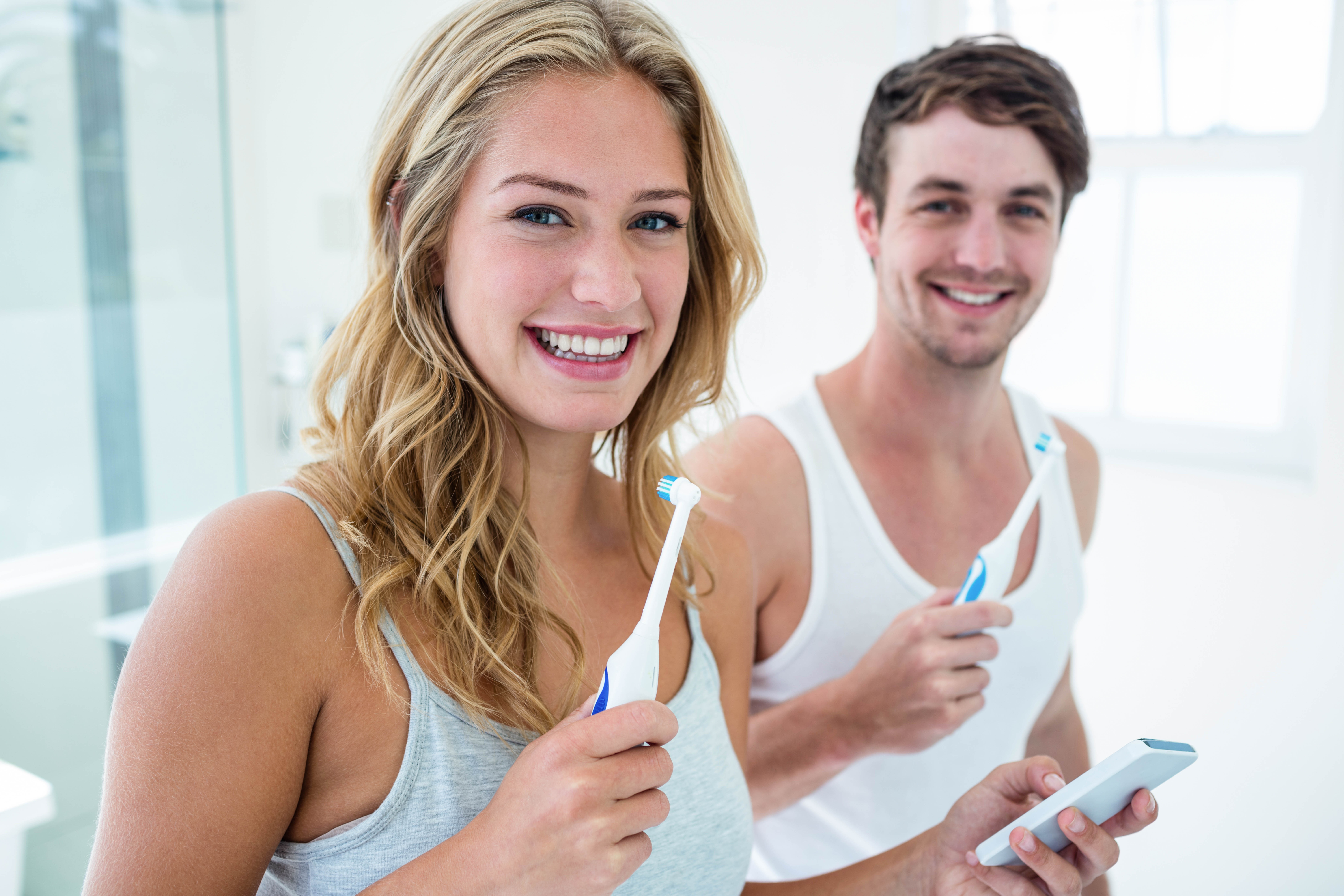Young Couple Brushing Their Teeth