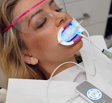 Patient Receiving Teeth Whitening Treatments at a Dentist Office