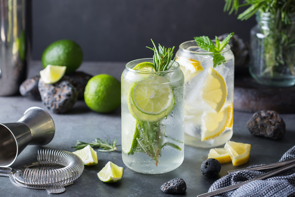 Two glasses of hard seltzer with lemons and limes