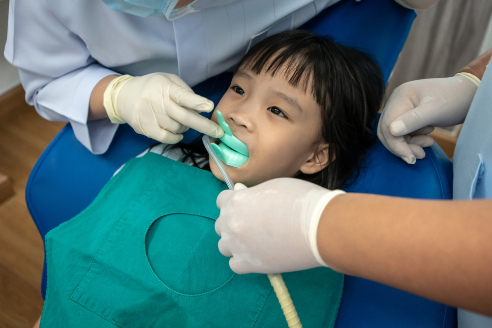 Young girl receiving a fluoride treatment