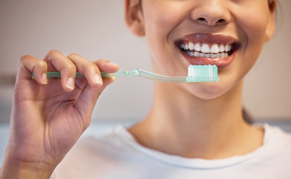 Smiling Woman Brushing Her Teeth