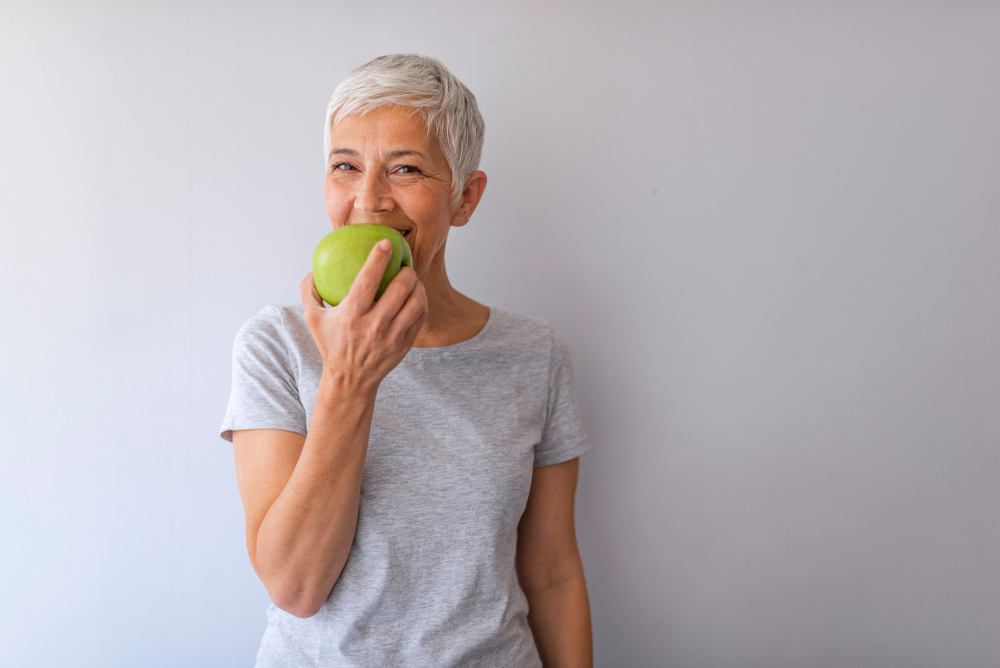 Woman biting into an apple