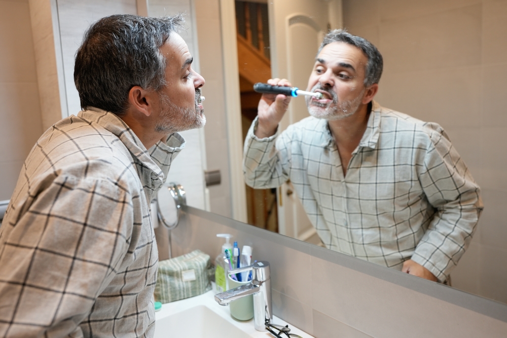 Man Using Electric Toothbrush